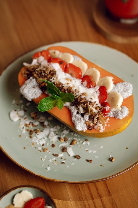 A papaya boat filled with granola, banana and strawberries at Cafe Lilu