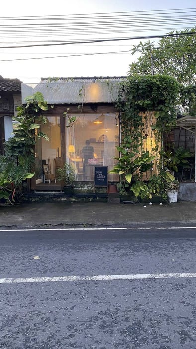 The street-facing shopfront covered in climbing plants at Decafo Cafe