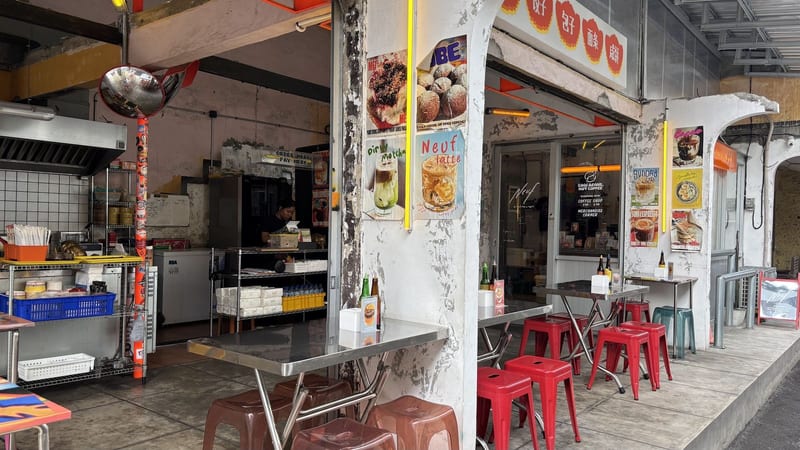 The open kitchen and red stools at the street-side counter at Double Dragon Temple