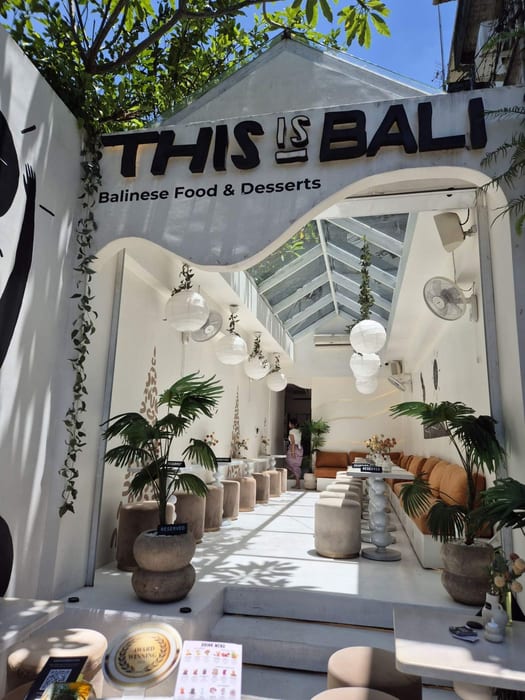 The entrance with the This Is Bali sign and white courtyard at This Is Bali