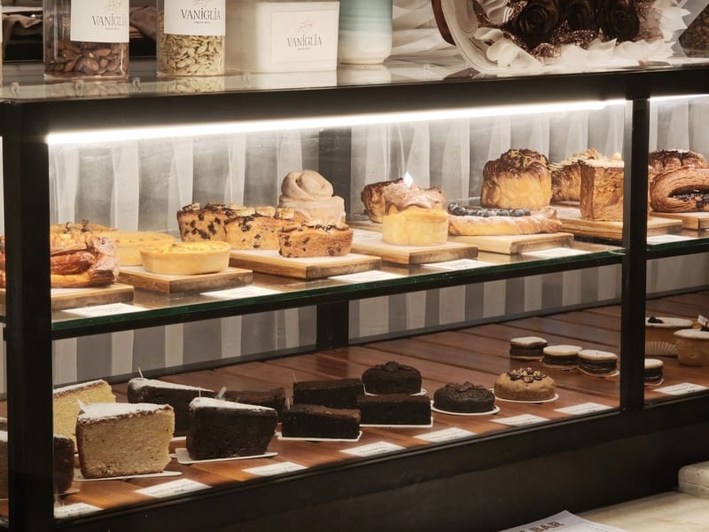 The pastry display case with cakes and croissants at Vaniglia Gelato and Pastry