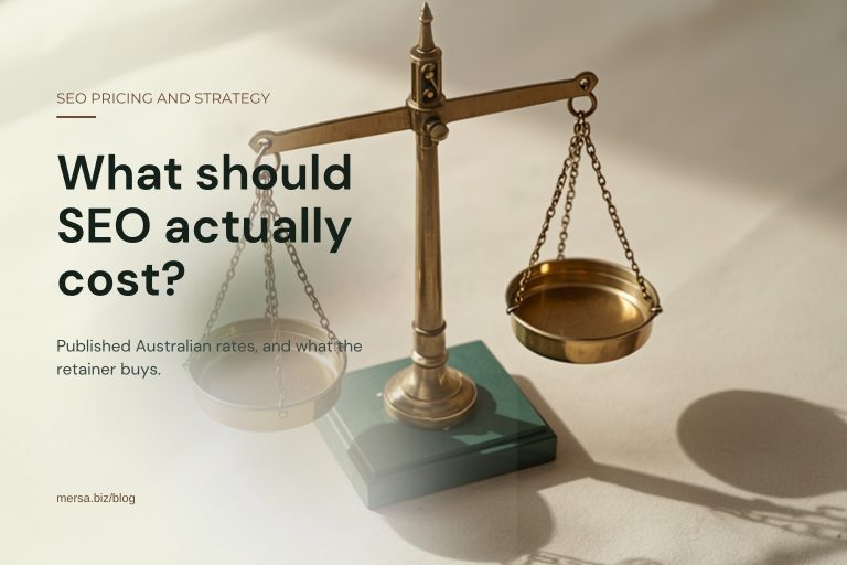A brass balance scale with two empty pans standing on a dark green base on a cream ground, captioned "What should SEO actually cost?".